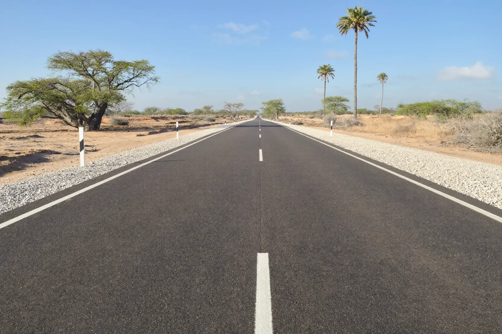 Completed low volume sealed road at DR3633 Tsandi–Ongulumbashe, with gravel shoulders and Namibian vegetation.